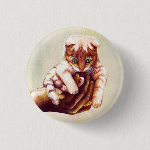 CAT IN HAND PINBACK BUTTON