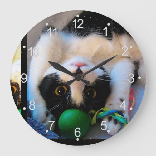 Cat is lying on the bed large clock