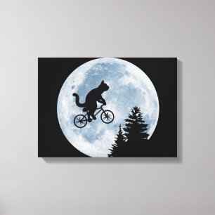 Cat is riding bicycle on the moon background. canvas print