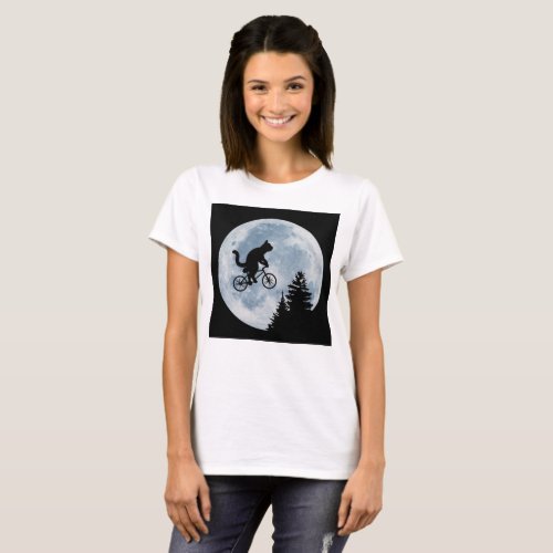 Cat is riding bicycle on the moon background T_Shirt