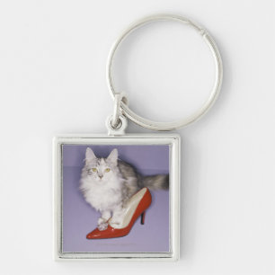 Cat stepping into high heel keychain