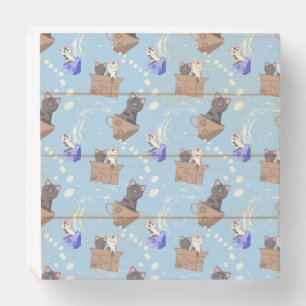 Cats in box and milk drops on blue