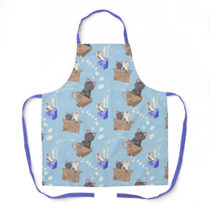 Cats in box and milk drops on blue apron