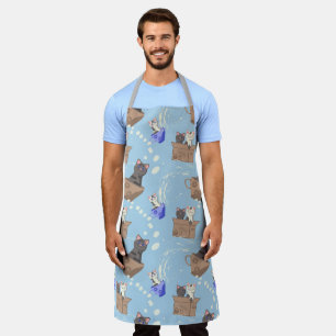 Cats in box and milk drops on blue apron