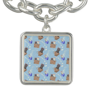 Cats in box and milk drops on blue bracelet