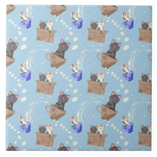 Cats in box and milk drops on blue ceramic tile