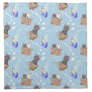 Cats in box and milk drops on blue cloth napkin