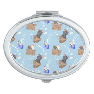 Cats in box and milk drops on blue compact mirror