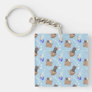 Cats in box and milk drops on blue keychain