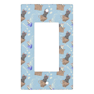 Cats in box and milk drops on blue light switch cover