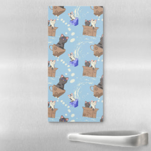 Cats in box and milk drops on blue magnetic notepad