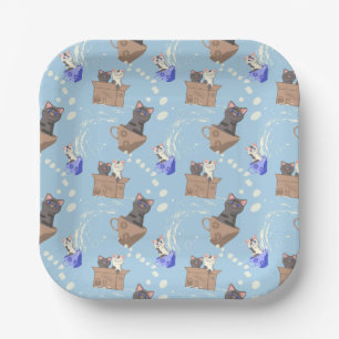 Cats in box and milk drops on blue paper plates