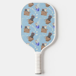Cats in box and milk drops on blue pickleball paddle
