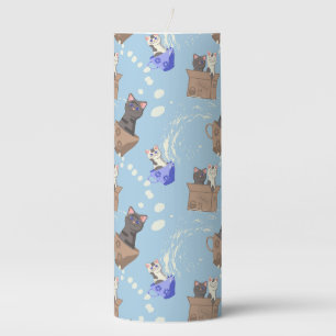Cats in box and milk drops on blue pillar candle
