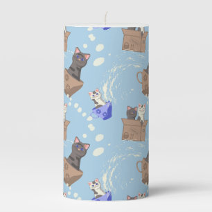 Cats in box and milk drops on blue pillar candle