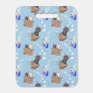 Cats in box and milk drops on blue seat cushion
