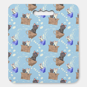 Cats in box and milk drops on blue seat cushion