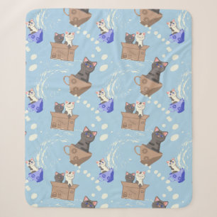 Cats in box and milk drops on blue sherpa blanket