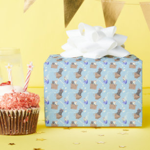 Cats in box and milk drops on blue wrapping paper