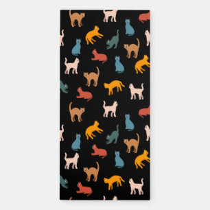 Cats on the black magnetic notepad