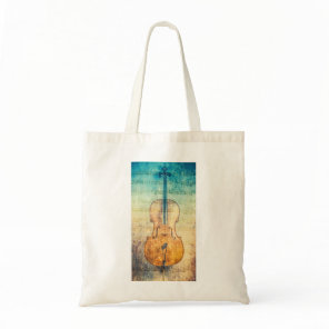 Cello with colorful sheet music background tote bag