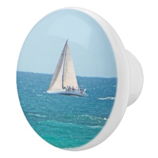 CERAMIC KNOB/SAIL BOAT WITH PEOPLE SITTING ALONG