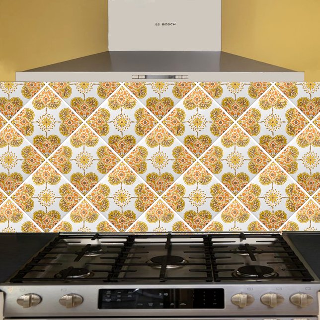Ceramic Tile with repeating ocher design (gold and orange  geometric tile shown  on a kitchen backsplash installed  diagonally.)