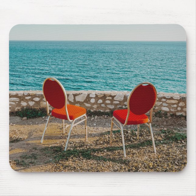 Chairs on coast of ocean under sky mouse pad (Front)