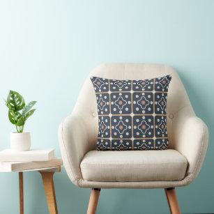 A charcoal gray striped lumbar pillow sits atop a wood and wicker accent  chair positioned at the corner of a white and gray…