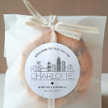 Charlotte Skyline | Wedding Welcome Message Classic Round Sticker<br><div class="desc">Enhance your wedding welcome packages or event party favors with a custom set of welcome stickers! These elegant yet minimal-style stickers are tailored for a wedding taking place in the beautiful city of Charlotte, North Carolina. They feature a modern deco skyline with the name of the city integrated underneath. All...</div>