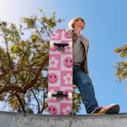 Checkered flowers and happy faces pink    skateboard