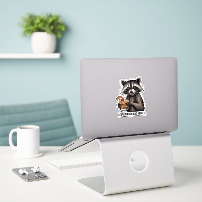 Cheeky Raccoon with Whiskey Sour – Playful Cocktai Sticker (Laptop On Desk)