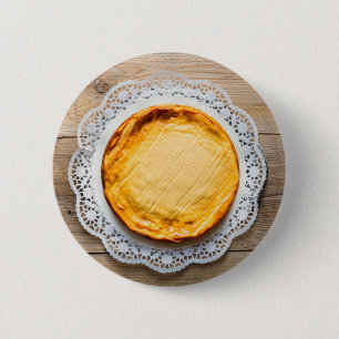 Cheesecake on rustic wood cake top. button