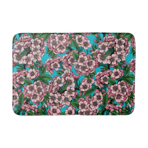 Cherry blossom on blue bath mat