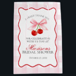 Cherry Sweet Pink Coquette Bow Bridal Shower Favor Medium Gift Bag<br><div class="desc">Someone cherry sweet is tying the knot and you’re the cherry on top of their sweet celebration. Add a nostalgic touch to your bridal shower with this Pink Gingham Cherry Party Decor featuring vibrant red cherries and pastel pink gingham, all within a whimsical wavy border. With this playful design, get...</div>