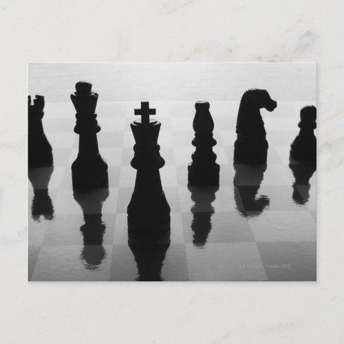 Chess pieces on chess board in black and white postcard