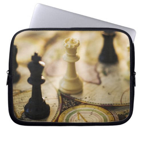Chess pieces on old world map laptop sleeve