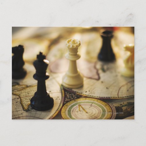 Chess pieces on old world map postcard