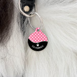Chic Black And Pink Dog Paws Pattern & Name Pet ID Tag<br><div class="desc">This stylish black and pink color design is split with a fun wave shape. On the bottom there is a curved personalizable text area for the name of the pet while on the top there is a pattern of white dog paw prints on a pink background color. On the back...</div>