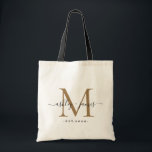 Chic Gold Monogram Script Names Wedding Date Tote Bag<br><div class="desc">Chic, modern gold monogrammed tote bag with your names and year established in black elegant hand lettered script calligraphy with a gold monogram. Simply add your names, monogram and year established beneath. Stylish design and perfect gift for the wedding guests of the newlywed couple. If you need any help or...</div>