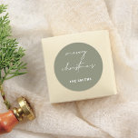 Chic Script Merry Christmas Lettering Green Classic Round Sticker<br><div class="desc">Bring a stylish touch to your holiday season with these stickers! Featuring "merry christmas" in elegant white script lettering and your family name in bold white sans serif typography, this sticker is perfect for adding a personal touch to gifts, envelopes, or holiday cards. Use it to seal packages, decorate gift...</div>