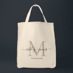 Chic Silver Monogram Script Names Wedding Date Tote Bag<br><div class="desc">Chic, modern silver monogrammed tote bag with your names and year established in black elegant hand lettered script calligraphy with a silver monogram. Simply add your names, monogram and year established beneath. Stylish design and perfect gift for the wedding guests of the newlywed couple. If you need any help or...</div>