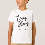 Chic Trendy Brush Black Script Team Groom T-Shirt<br><div class="desc">T-shirt featuring the words "Team Groom" in chic trendy brush black script that's perfect for the ring bearer. For other matching items see here https://www.zazzle.com/collections/119250194970828530?rf=238364477188679314 Personalize it by replacing the placeholder text. For more options such as to change the font and it's size, color or the spacing between letters click...</div>