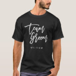 Chic Trendy Brush White Script Team Groom T-Shirt<br><div class="desc">T-shirt featuring the words "Team Groom" in chic trendy brush white script that's perfect for groomsmen and best men. For other matching items see here https://www.zazzle.com/collections/119250194970828530?rf=238364477188679314 Personalize it by replacing the placeholder text. For more options such as to change the font and it's size, color or the spacing between letters...</div>