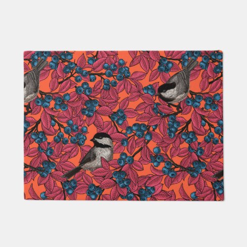 Chickadee birds on blueberry branches on orange doormat