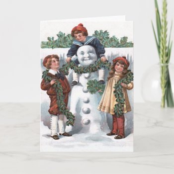 Children Hanging Holly Garland Snowman Holiday Card by kinhinputainwelte at Zazzle