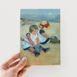 Children on the Beach | Mary Cassatt Postcard<br><div class="desc">Children on the Beach (1884) by Mary Cassatt captures a tender moment of two children playing by the seaside. The painting features soft, muted colors and gentle brushstrokes that reflect the carefree innocence of childhood. Cassatt's impressionist style brings the tranquil beach setting and the children's interaction to life with subtle...</div>