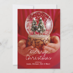 Child's hands holding snow globe holiday card