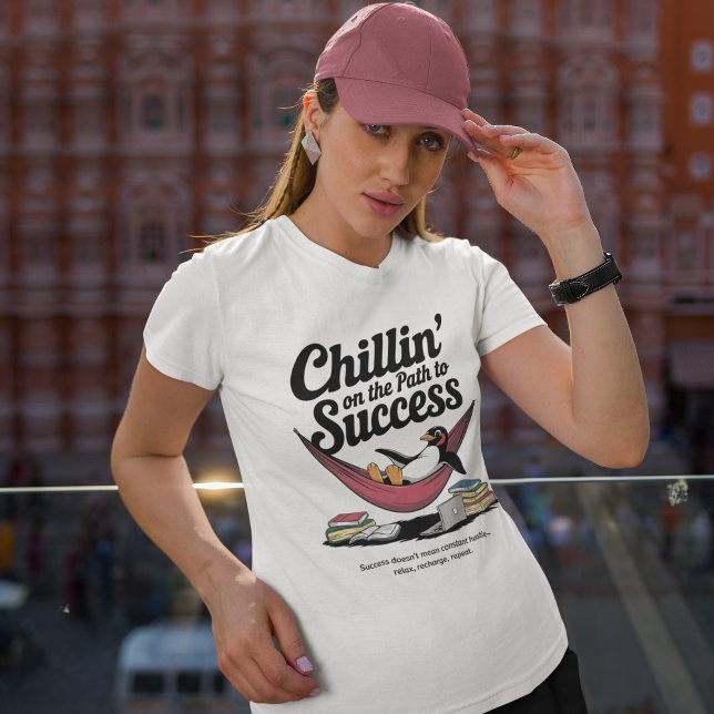 Chillin' on the Path to Success Inspiration T-Shirt (woman wearing white graphic t-shirt with a penguin resting in a hammock featuring typography on top)