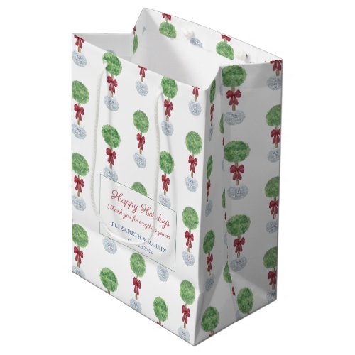 Chinoiserie Chic Boxwood Topiary Merry Christmas Medium Gift Bag - The background of this gift bag design is a repeat pattern made from a lollipop boxwood topiary in a blue and white ginger jar planter and adorned with a red bow. These watercolor elements were originally handpainted by me, before being scanned into digital form. The text shown is for a Happy Holidays or thank you bag but all of the text fields are customizable to your needs. 